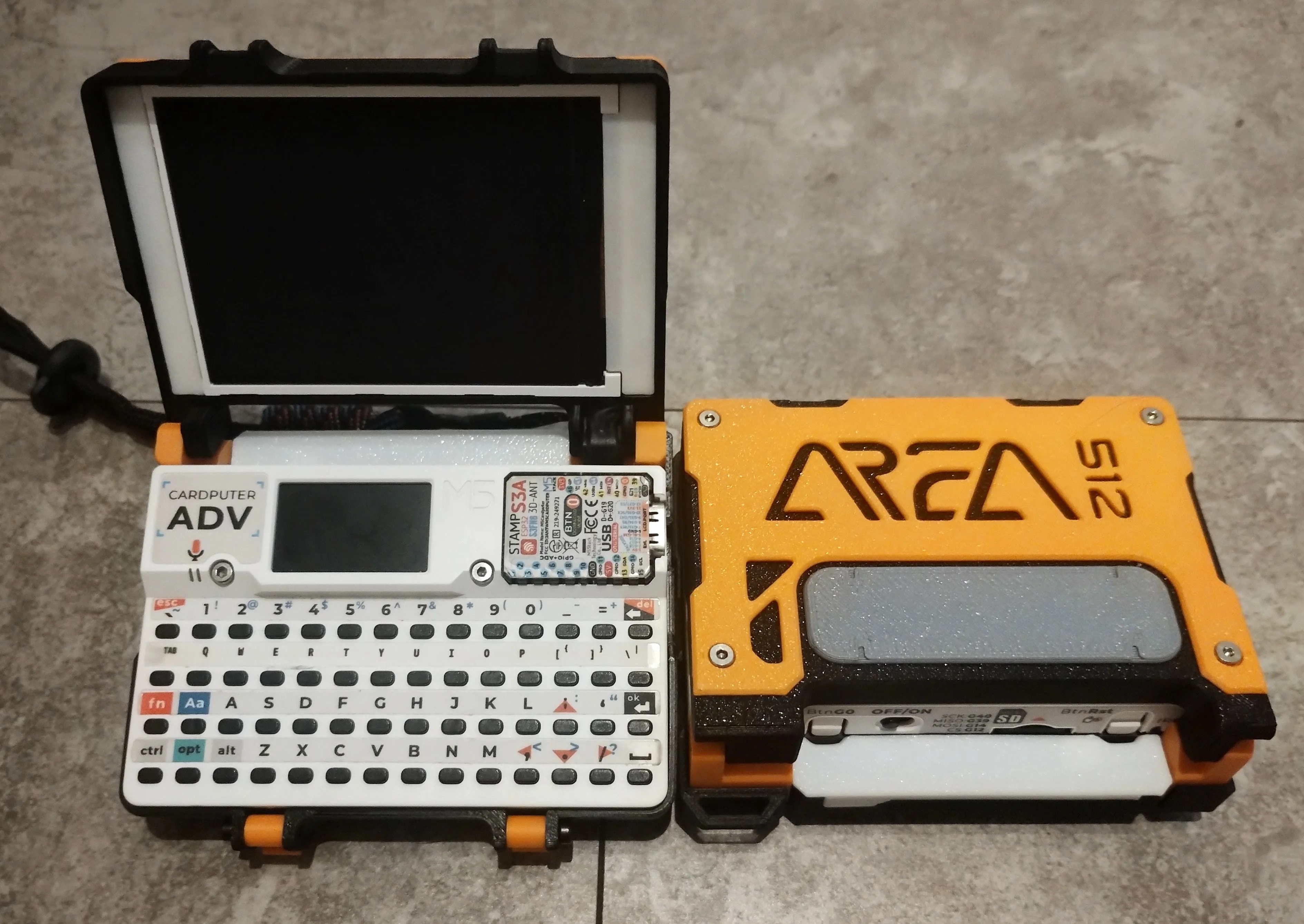TERM512 open with its external display and keyboard, alongside a closed case